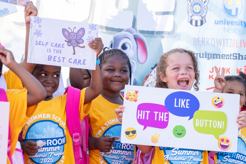 Children holding wellness signs at KC Zoo Wellness Day