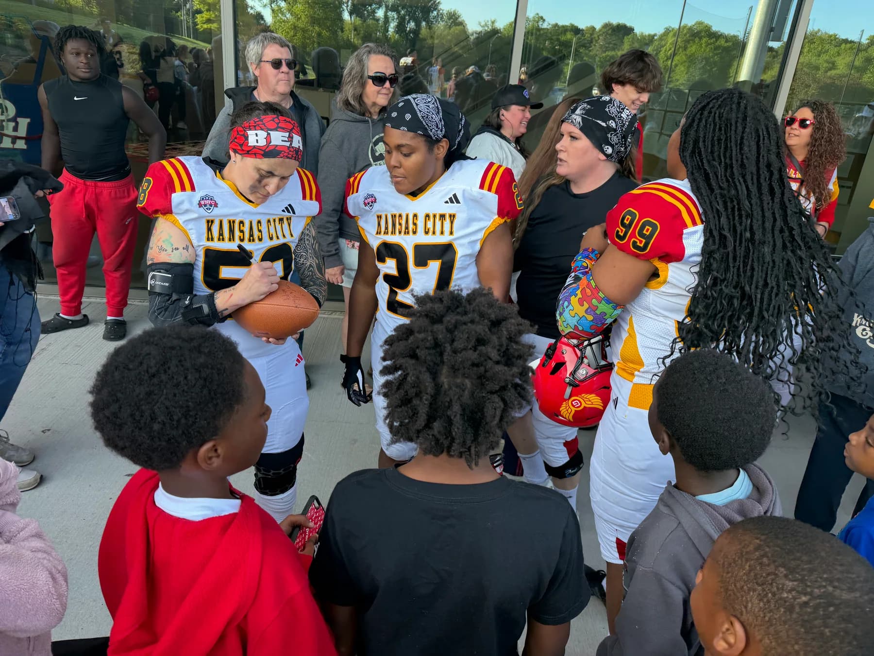 Kansas City football players engaging with young participants