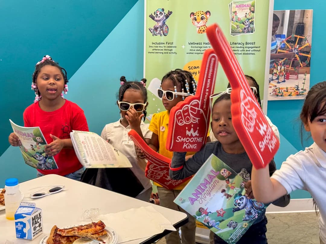 Students holding books and celebration items at Operation Breakthrough