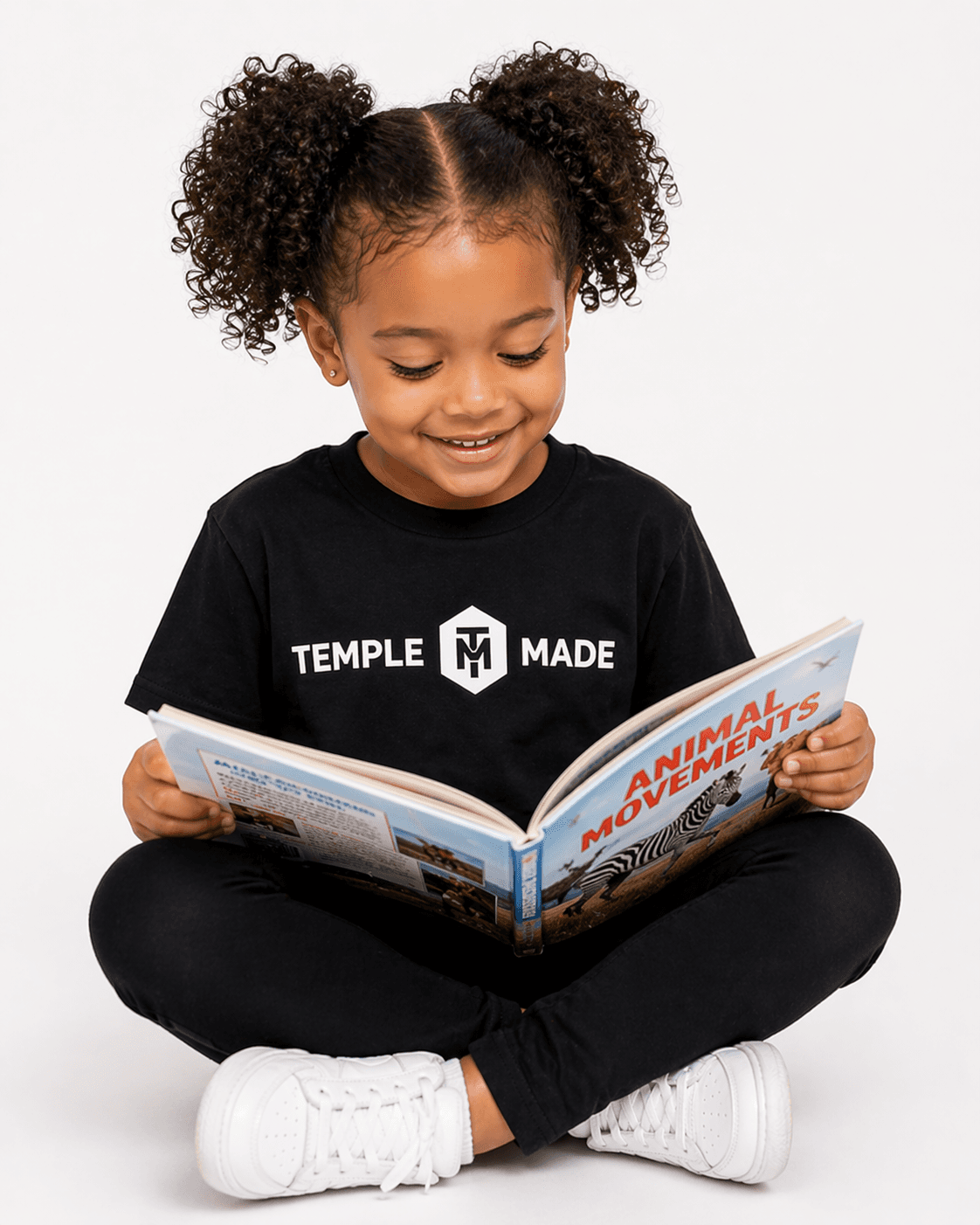 A Temple Made child reading the Animal Movements book