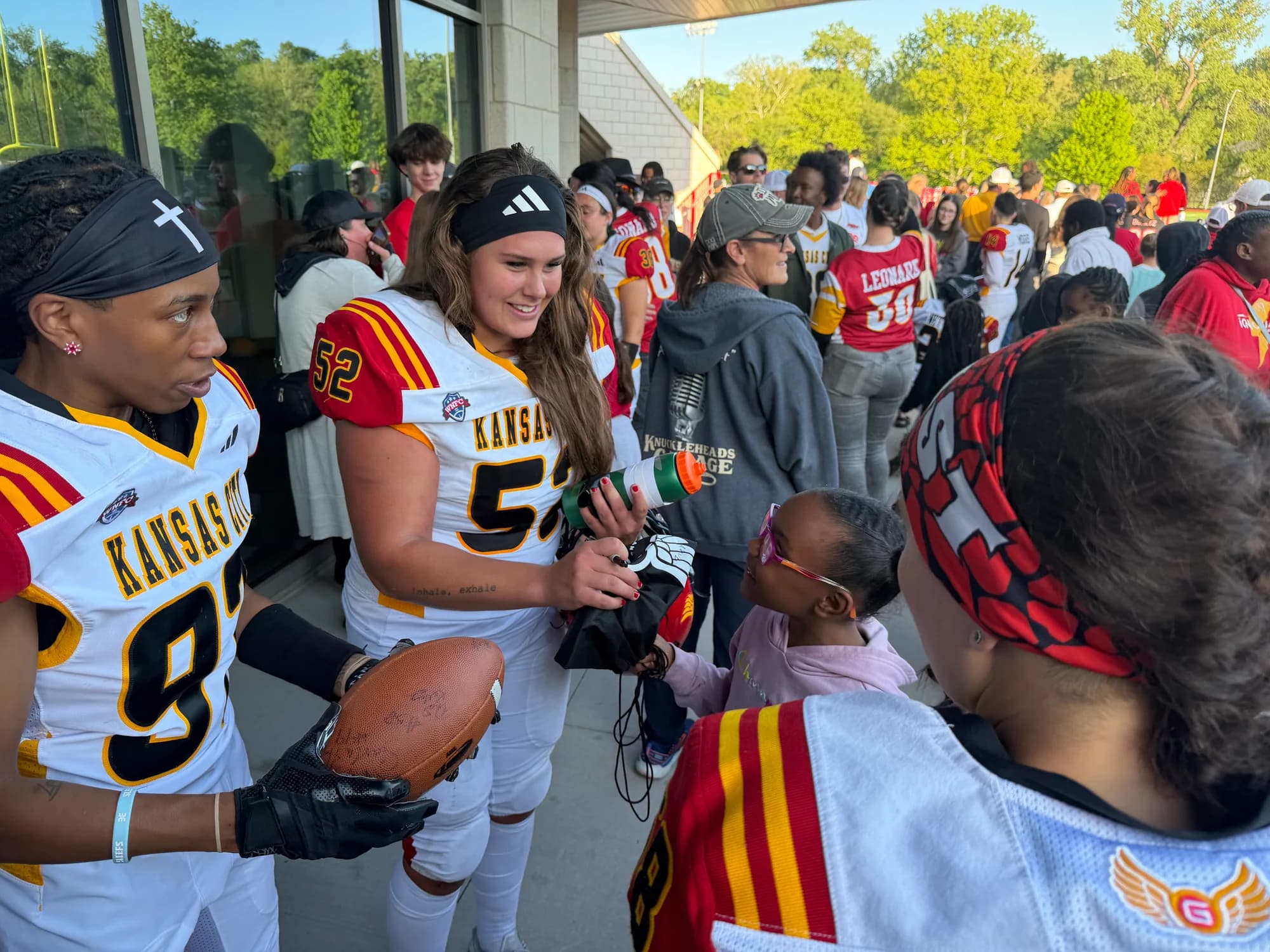 Kansas City football players connecting with children on game day