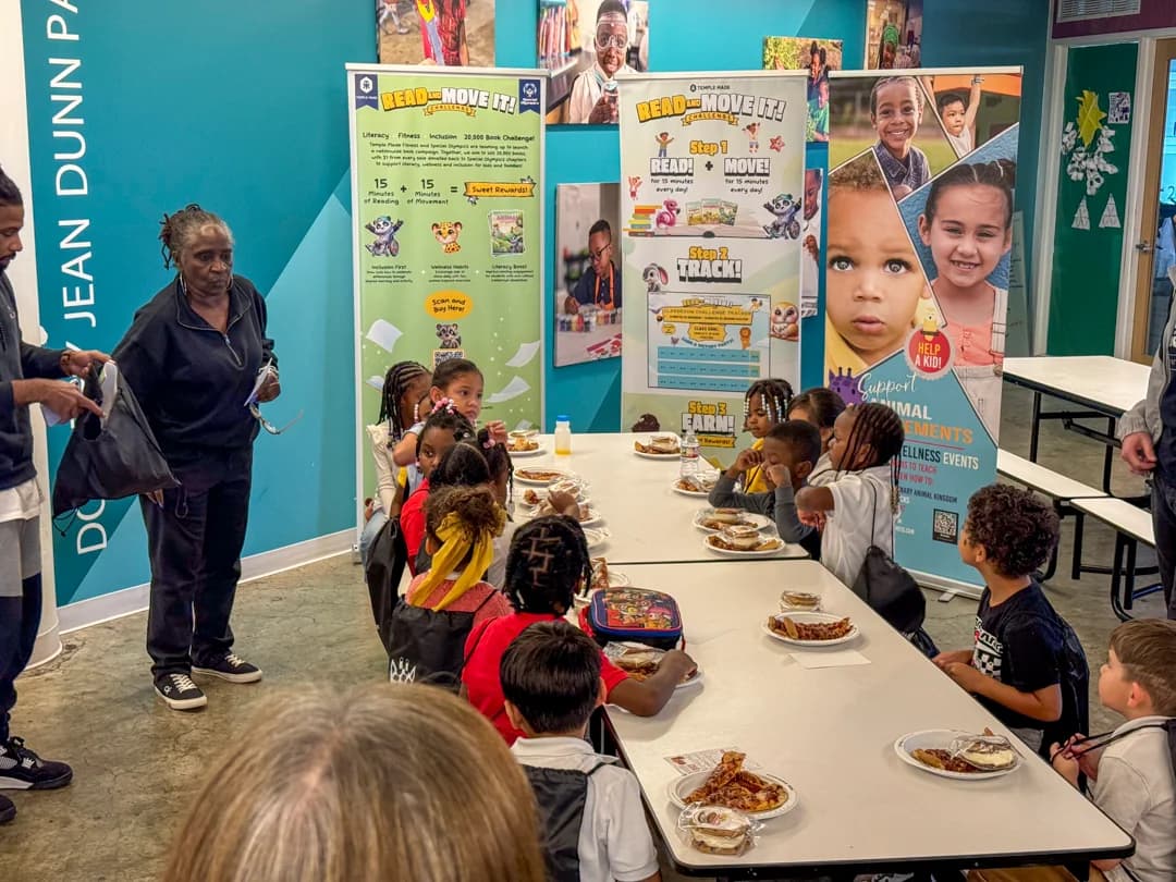 Students gathered around a Read and Move It celebration table at Operation Breakthrough